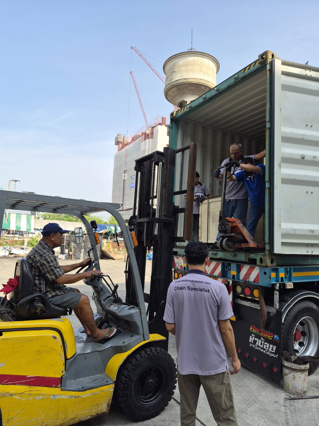 MPC Chain Specialist overseeing forklift-assisted container offload of industrial chain crates
